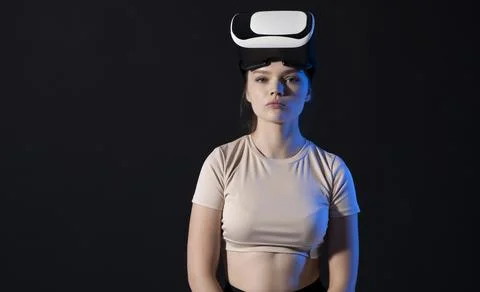 Metaverse and virtual technology concept. Young woman in virtual reality headset Stock Photos