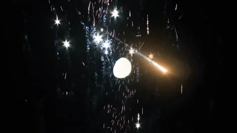 Meteor Falling at Night With Fireworks Exploding Over the Moon   Stock Footage 303007640