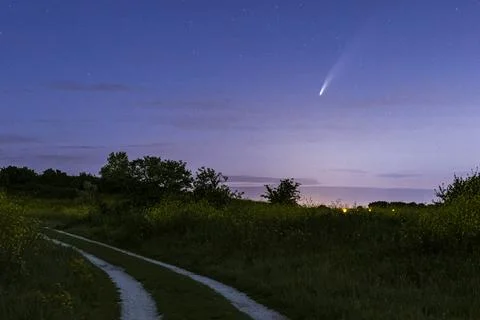 Meteor, shooting star or falling star seen in a night sky with clouds. Comet  Stock Photos