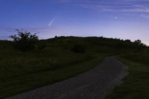 Meteor, shooting star or falling star seen in a night sky with clouds. Comet  Stock Photos