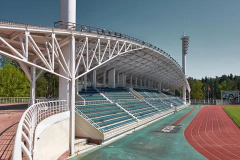 Meteor Stadium, empty rows of seats under canopy and red running tracks, land Stock Photos
