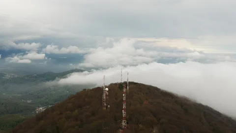 A meteorological radar with a large white sphere on top of a mountain collects Stock Footage 154432830