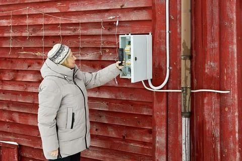 Meter imaging frames rural resident with brown hair using smartphone opposi.. Stock Photos