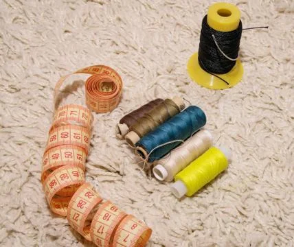 Meter, multi-colored spools of thread lie on a white background Stock Photos