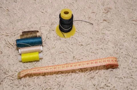 Meter, multi-colored spools of thread lie on a white background Stock Photos