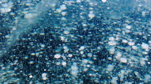 Methane bubbles under thick blue lake ice. Frozen cold winter water surface. Stock Footage 344685608