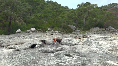 Methane flames burst from rocky ground cracks, natural gas fire - Gas Combustion Video stock 339818637