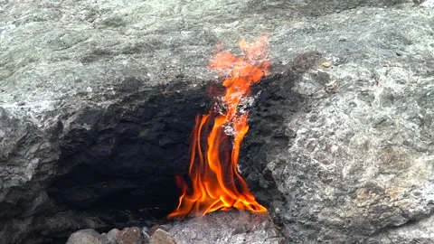 Methane flames burst from rocky ground cracks, natural gas - Geological Fire Stock Footage 339818681