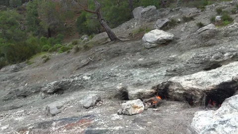 Methane flames burst from rocky ground cracks, natural gas fire - Gas Release Stock Footage 339818698