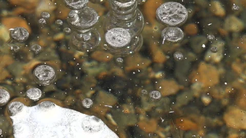 Methane gas bubbles stay trapped inside clear frozen lake ice - Frozen Surface Stock Footage 339817934