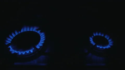 Methane gas burners on a kitchen go out in sequence in the dark with blue light Video stock 170387698