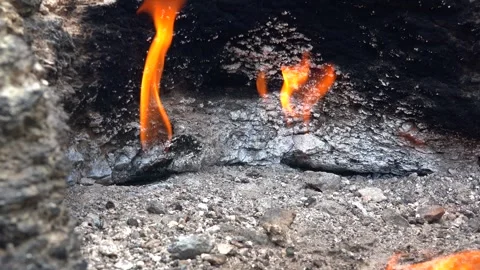 Methane gas fire burns between rocks on barren - Natural Gas and Ground Seepage Stock Footage 339562596