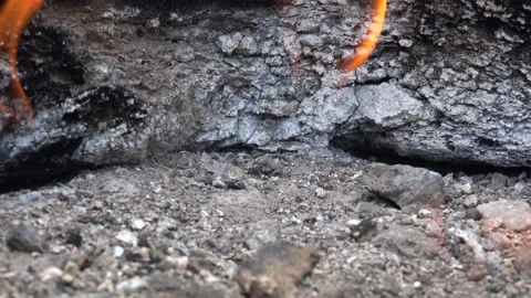 Methane gas fire burns between rocks on barren - Natural Gas and Vapor Emission Stock Footage 339562715