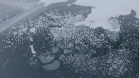 Methane gas ice bubbles in Arctic permafrost lake, ungraded LOG Stock Footage 148392213