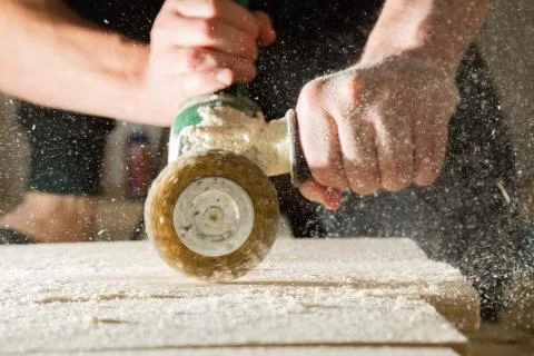 Method of artificial aging of wood. Drill with a wire brush. Stock Photos