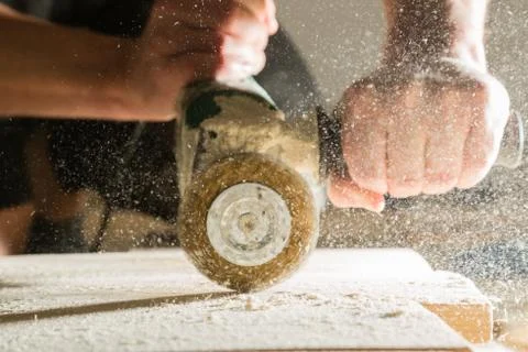 Method of artificial aging of wood. Drill with a wire brush. Stock Photos