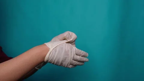 Method of taking off latex medical gloves isolated blue background Stock Footage 271218068