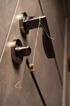 Method of tooth extraction. A real human wisdom tooth hangs by a thread on .. Stock Photos