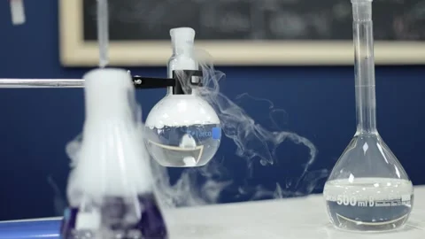 In a methodical slow-motion capture, glass beakers in a laboratory bubble Stock Footage 252194527