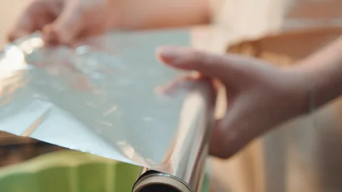 Methodically preparing kitchen implements for baking activities. Diligently Stock Footage 337453500