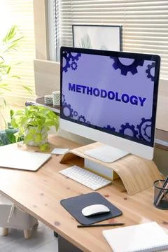 Methodology concept. Workplace with modern computer on wooden table Stock Photos