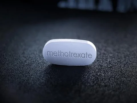 Methotrexate pill on black table Stock Photos