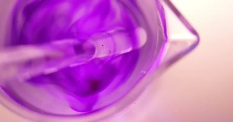 Methyl Violet (C24H28ClN3) Particles Dissolving in Water Measuring Beaker Top Stock Footage 322599236