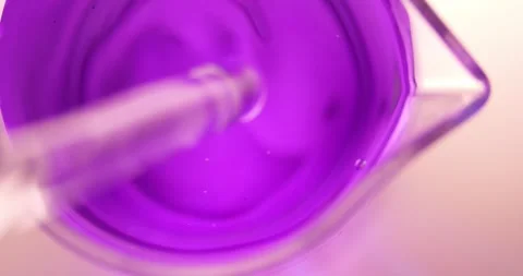 Methyl Violet (C24H28ClN3) Purple Solution in Measuring Glass Beaker, Glass Rod Stock Footage 322600566
