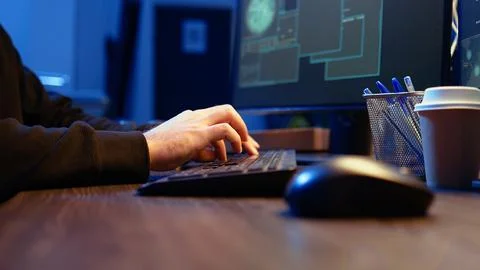 Meticulous hacker typing on computer keyboard, close up 写真素材