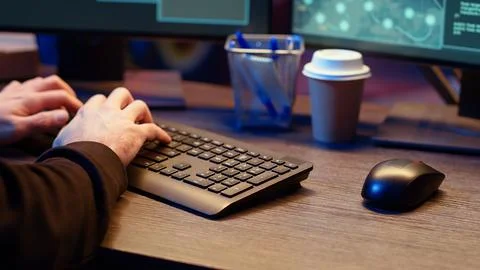Meticulous hacker typing on computer keyboard, close up Stockfoto's