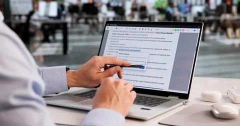 Meticulous Proofreader Examines Laptop Document, Fixing Spelling Mistakes Wit Stock Photos