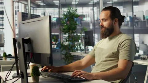 Meticulous staff member imputing data on computer in office Stock Footage 318235604