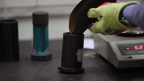 Meticulously performing a quality control test for sand casting Stock Footage 321339349