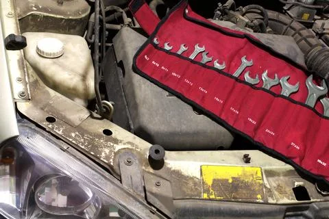 Metric spanner set. garage tools in cloth bag upon the engine under the hood Stock Photos