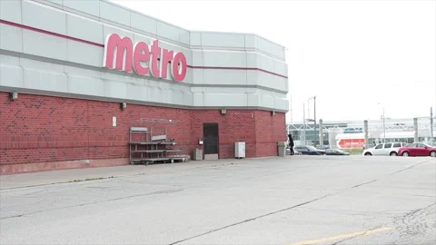 Metro grocery store chain side parking back lot with cars parking in front, wide Stock Footage 249752594