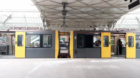 Metro light rail train standing at platform with doors open Stock Footage 170832748