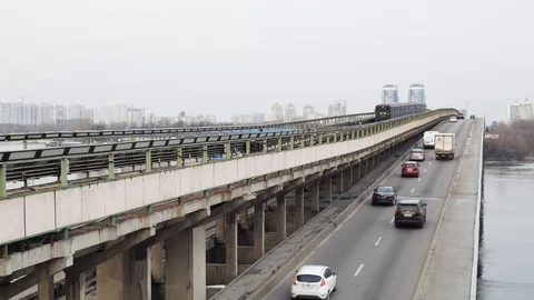 Metro line and the old blue train passing over the bridge Stock Footage 105329280