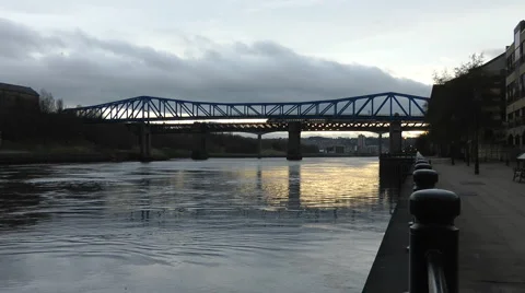 Metro Rail bridge over river Tyne at sunset in winter Stock Footage 1102296
