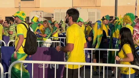 Metro station queue in Doha Qatar with Happy Brazil Fan from men women Stock Footage 228597559
