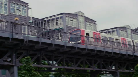 Metro Subway Train Passing Elevated Line in Front of Buildings in Urban City Stock-Footage 173526727