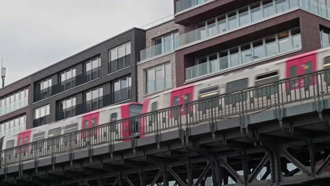 Metro Subway Train Passing Elevated Line in Front of Buildings in Urban City Stock-Footage 173528518