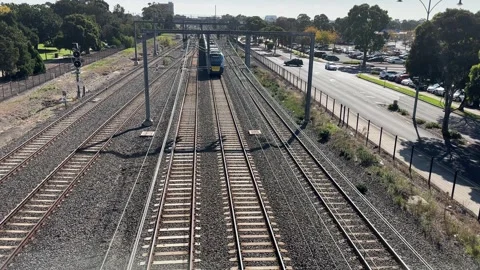 A metro train approaches Sunshine Station in Melbourne Australia Vídeos de archivo 334087387