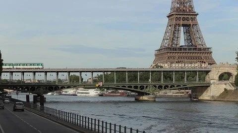 Metro train on the bridge over the river close to the Eiffel tower in Paris Stock Footage 73077263