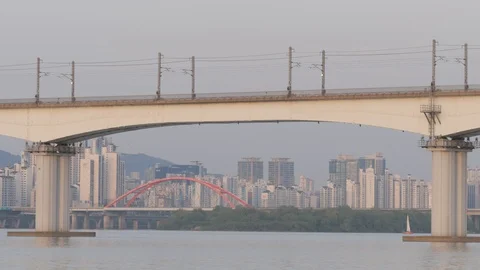 Metro train on bridge with skyline view and Seogang bridge,Seoul,South Korea Stock Footage 112904732
