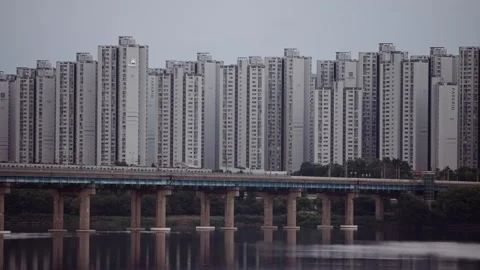 Metro train crossing bridge over Han River towards Seoul skyline Stock Footage 314072643
