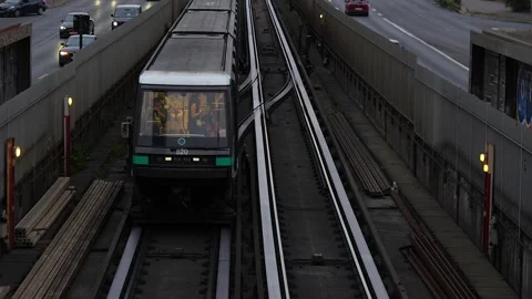 Metro train on elevated tracks above Paris traffic, June 15 2025 Video stock 311321808