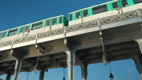 Metro train going over the bridge in Paris against the sky Stock Footage 233596422