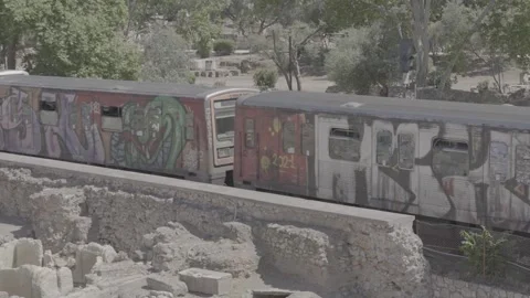 A metro train in motion in Athens, Greece, with a view of the Acropolis Stock Footage 346683959