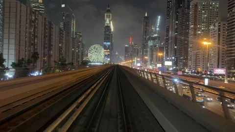 A metro train moves along Sheikh Zayed Road at night in Dubai at night. View  Stock Footage 282793549