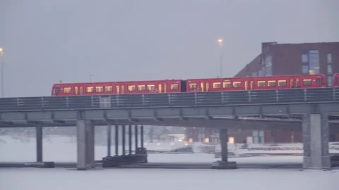 The metro train is moving on the bridge during the snowstorm Stock Footage 170427644